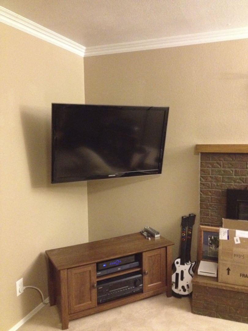 wall mounted tv in a corner of the room